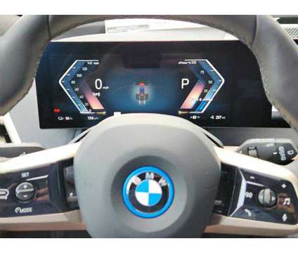 2025 BMW iX xDrive50 is a Red 2025 BMW 325 Model iX SUV in Loveland CO