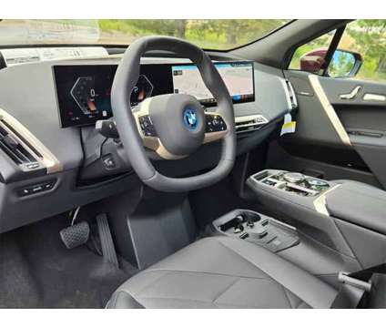 2025 BMW iX xDrive50 is a Red 2025 BMW 325 Model iX SUV in Loveland CO