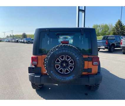 2011 Jeep Wrangler Sport is a Yellow 2011 Jeep Wrangler Sport SUV in Houghton Lake MI