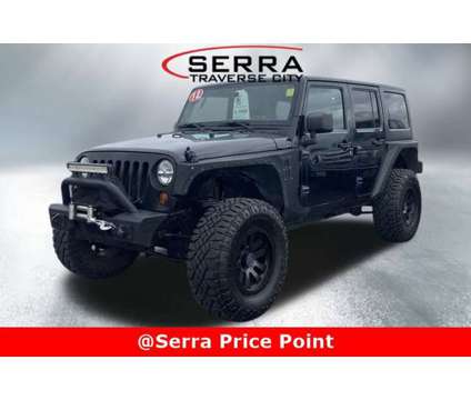 2012 Jeep Wrangler Unlimited Sahara is a Black 2012 Jeep Wrangler Unlimited Sahara Car for Sale in Traverse City MI