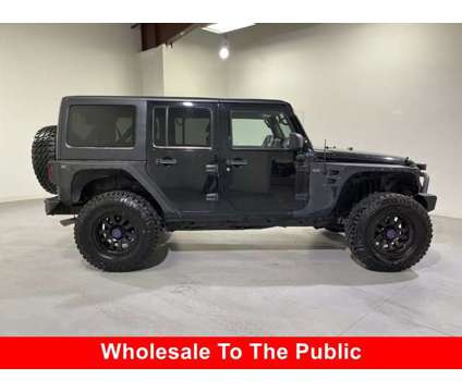 2012 Jeep Wrangler Unlimited Sahara is a Black 2012 Jeep Wrangler Unlimited Sahara Car for Sale in Traverse City MI