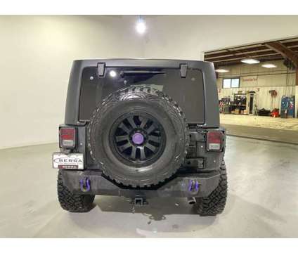 2012 Jeep Wrangler Unlimited Sahara is a Black 2012 Jeep Wrangler Unlimited Sahara Car for Sale in Traverse City MI