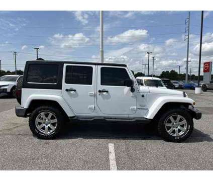 2015 Jeep Wrangler Unlimited Sahara is a White 2015 Jeep Wrangler Unlimited Sahara Car for Sale in Southaven MS