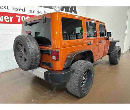 2011 Jeep Wrangler Unlimited Sahara is a Yellow 2011 Jeep Wrangler Unlimited Sahara SUV in Chandler AZ