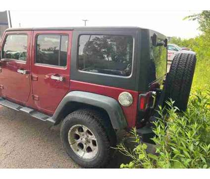 2012 Jeep Wrangler Unlimited Sport is a Red 2012 Jeep Wrangler Unlimited Sport SUV in Dubuque IA