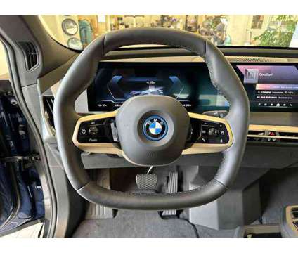 2025 BMW iX xDrive50 is a Blue 2025 BMW 325 Model iX SUV in Westbrook ME