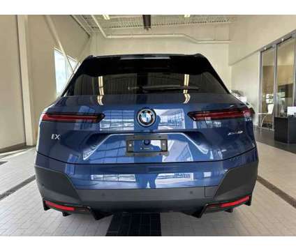 2025 BMW iX xDrive50 is a Blue 2025 BMW 325 Model iX SUV in Westbrook ME