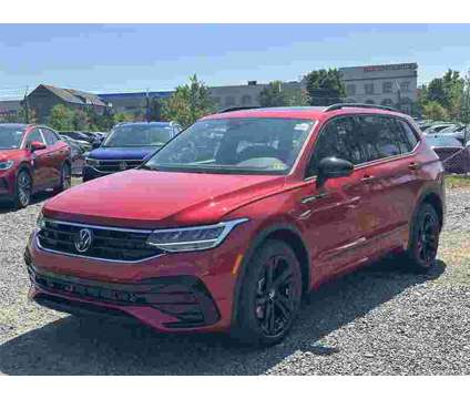 2024 Volkswagen Tiguan SE R-Line Black is a Red 2024 Volkswagen Tiguan SE SUV in Sterling VA