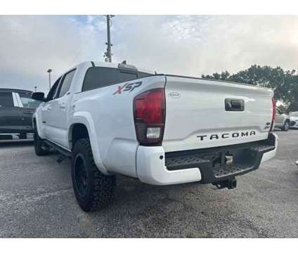 2018 Toyota Tacoma SR5 V6 is a White 2018 Toyota Tacoma SR5 Truck in Orlando FL