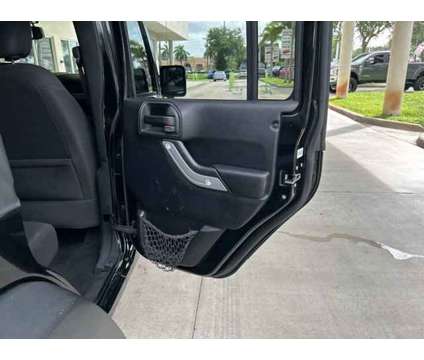 2015 Jeep Wrangler Unlimited Sport is a Black 2015 Jeep Wrangler Unlimited Sport SUV in Fort Lauderdale FL