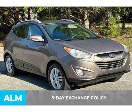 2013 Hyundai Tucson GLS is a Tan 2013 Hyundai Tucson GLS SUV in Lithia Springs GA